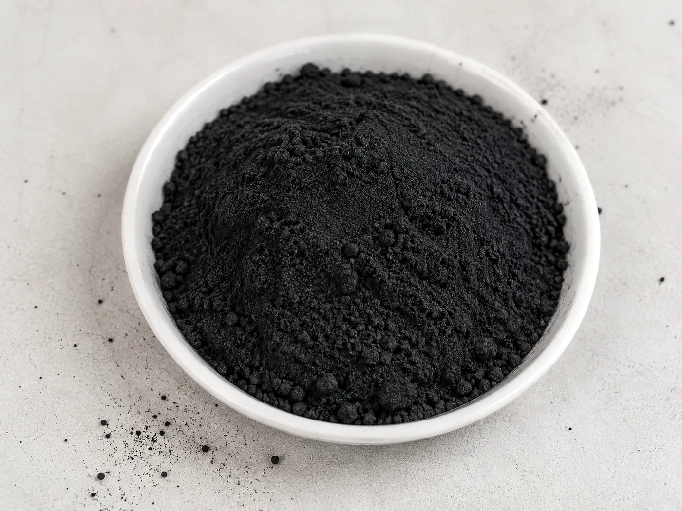 Wood based powdered activated carbon in a ceramic bowl