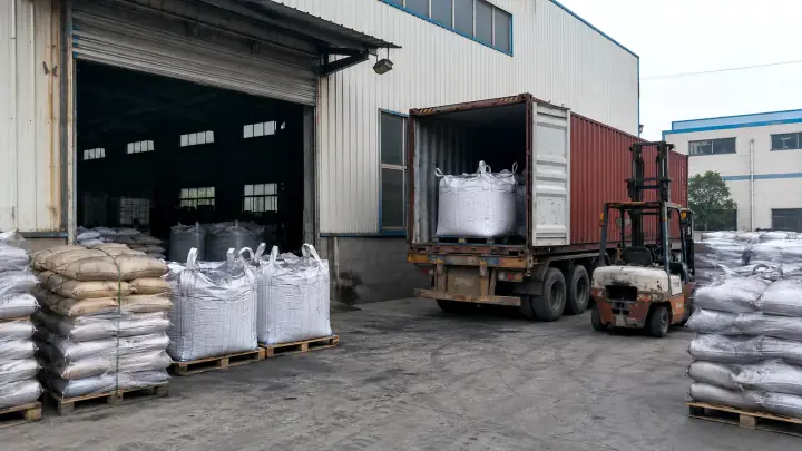 Forklift loading activated carbon bulk bags into an export container